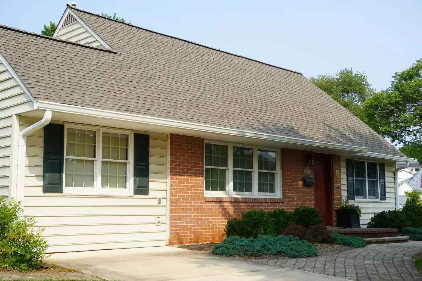 White gutters along a low residential roofline