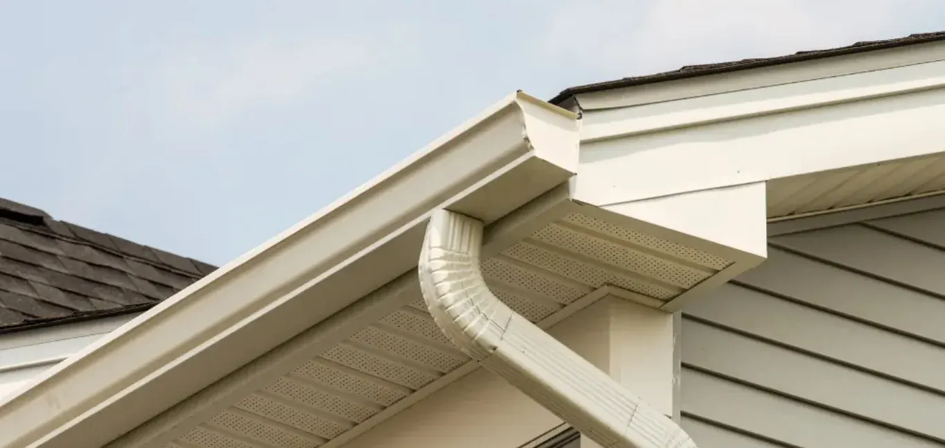 White gutter and downspout connection at a residential gable